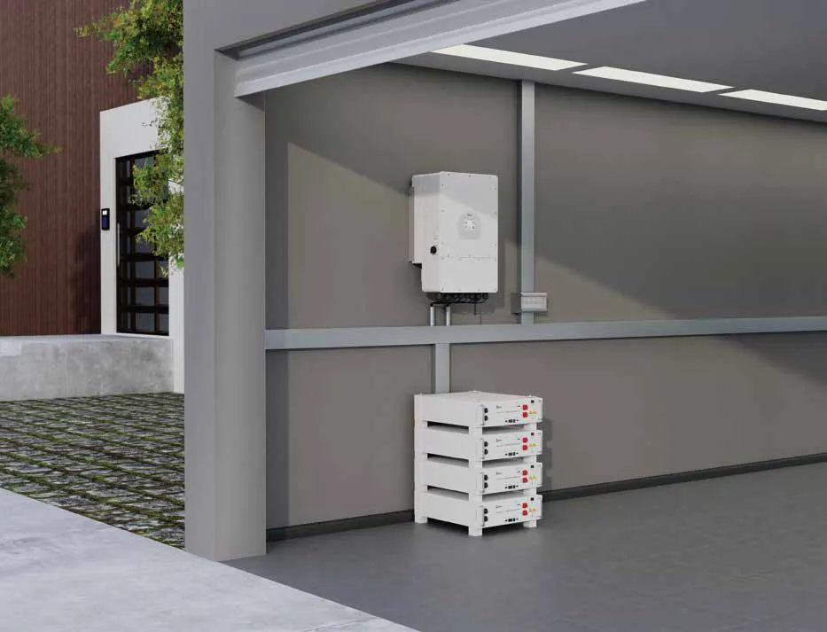 A Deye hybrid inverter on a carport wall above a stack of rack-mount batteries (Deye render)