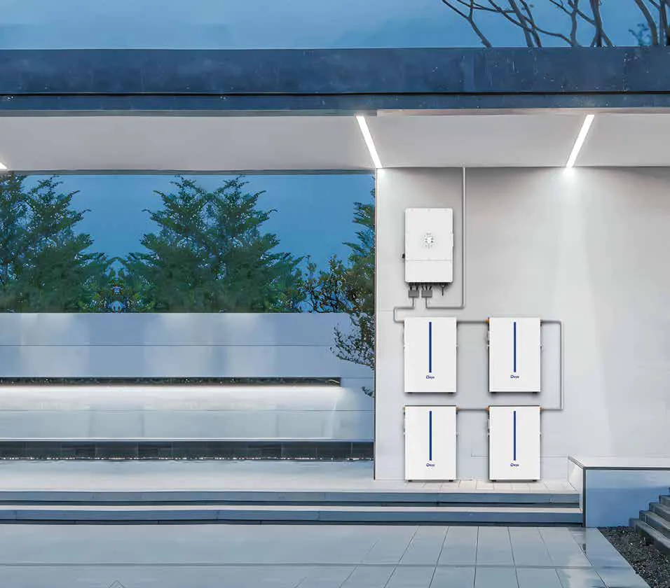 A Deye hybrid inverter above four slim wall-mounted Deye batteries (Deye render)